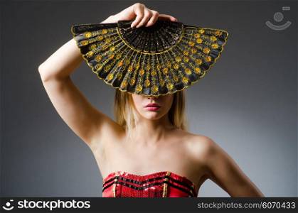 Woman dancing with fans in arts concept