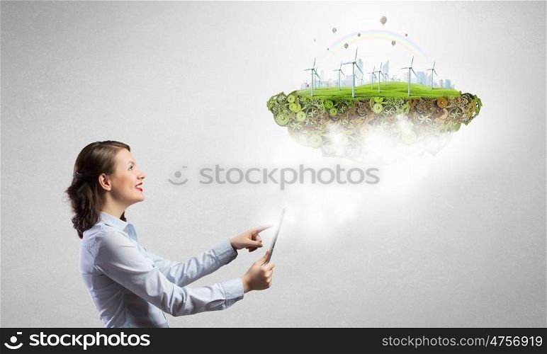 Woman demonstrating alternative energy concept . Young woman presenting on tablet perfect ecology land with windmills