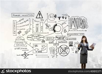 Woman demonstrating marketing plan. Young businesswoman drawing her strategy plan on screen