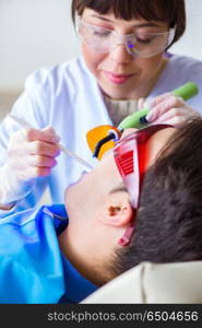 Woman dentist doctor with male patient in hospital