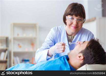Woman dentist doctor with male patient in hospital