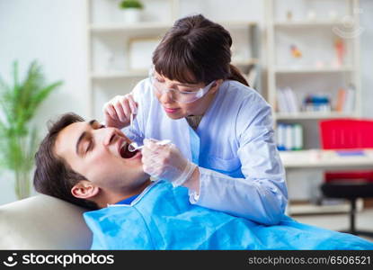 Woman dentist doctor with male patient in hospital