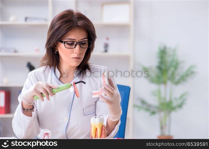 Woman dentist working on teeth implant