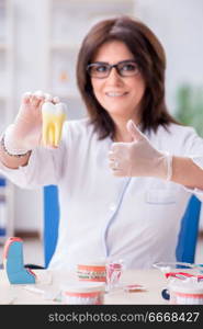 Woman dentist working on teeth implant