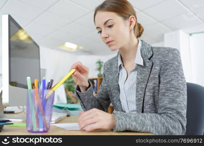 woman designer chooses a pen