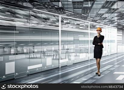 Woman designer in interior. Attractive elegant woman in helmet in modern interior. Mixed media