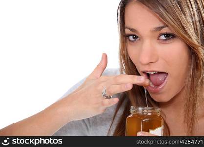 woman dipping finger into jam