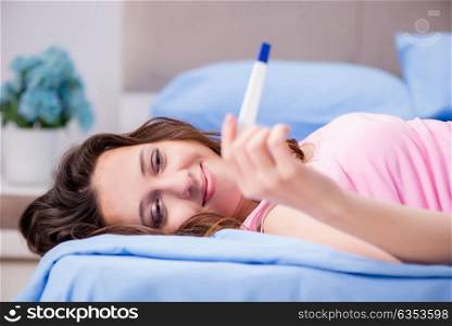 Woman discovering her positive pregnancy test