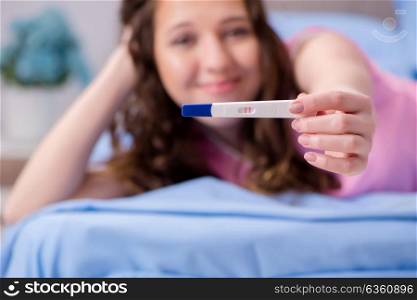Woman discovering her positive pregnancy test