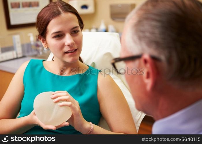 Woman Discussing Breast Augmentation With Plastic Surgeon