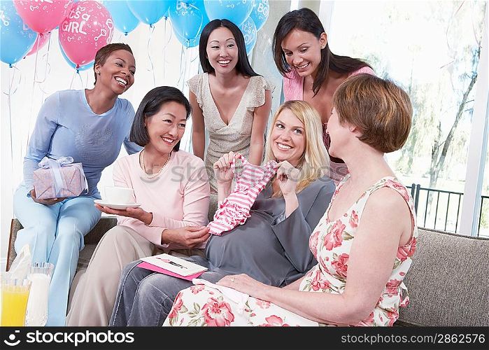 Woman Displaying a Gift at Her Baby Shower
