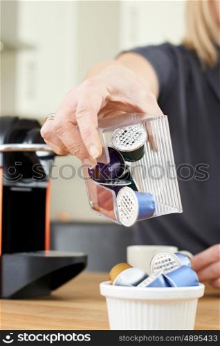 Woman Disposing Of Used Coffee Capsules