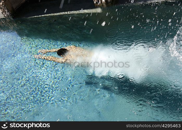 Woman diving into swimming pool