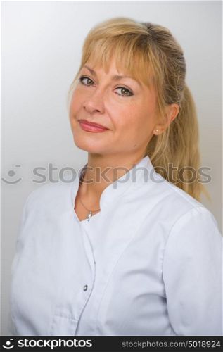 Woman Doctor At The Hospital Standing Against The Wall