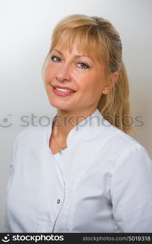 Woman Doctor At The Hospital Standing Against The Wall