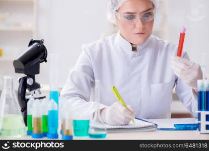 Woman doctor checking blood samples in lab