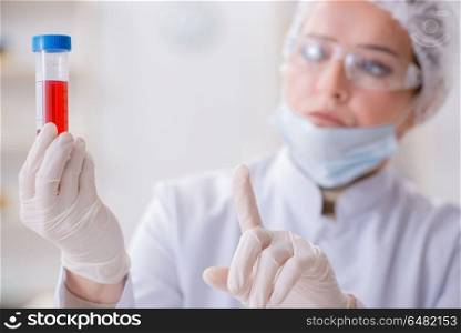 Woman doctor checking blood samples in lab