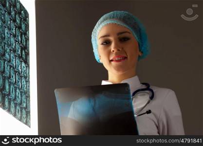 Woman doctor holding x-ray. Image of attractive woman doctor holding x-ray results