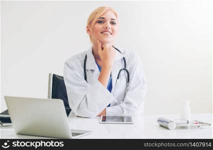 Woman doctor in hospital or healthcare institute working on medical report at office table.. Doctor in hospital working on medical report.