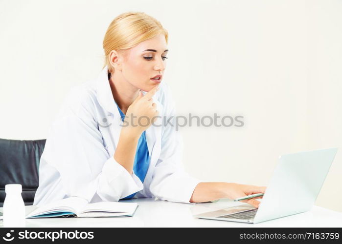 Woman doctor in hospital or healthcare institute working on medical report at office table.