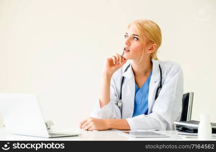 Woman doctor in hospital or healthcare institute working on medical report at office table.. Doctor in hospital working on medical report.