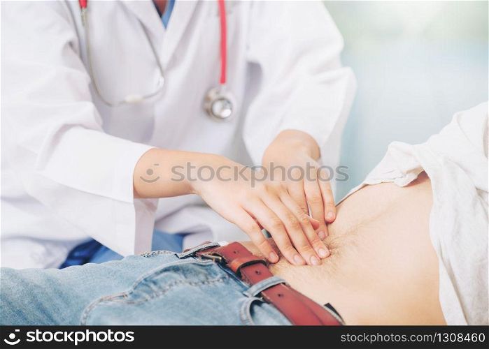 Woman doctor is talking and examining male patient in hospital office. Healthcare and medical service.. Woman Doctor and Male Patient in Hospital Office