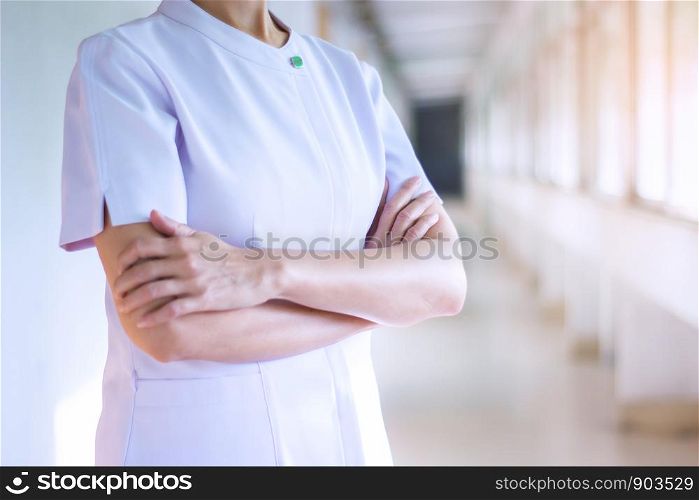 woman doctor or nurse posing with hands crossed in white uniform.health care concept