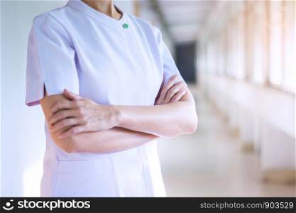 woman doctor or nurse posing with hands crossed in white uniform.health care concept