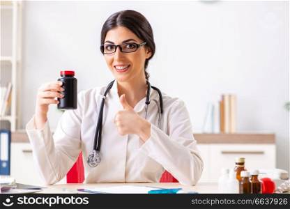 Woman doctor with bottle of medicines