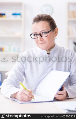 Woman doctor writing case