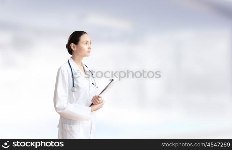 Woman doctor. Young attractive woman doctor with stethoscope on neck