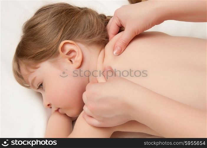woman does massage to the little girl
