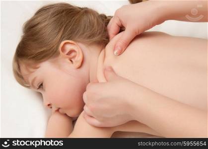 woman does massage to the little girl