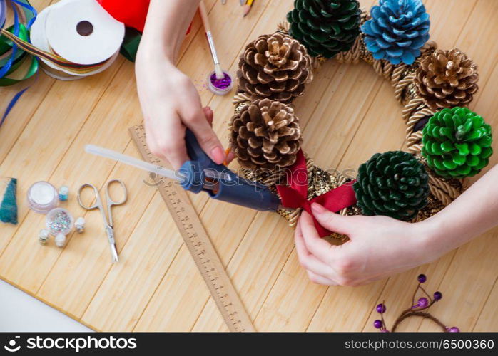 Woman doiing DIY festive decorations at home