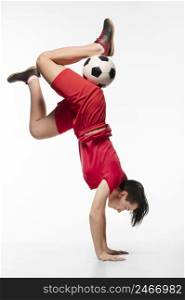 woman doing acrobatics with football ball 2