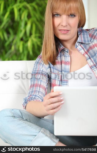 woman doing computer on her couch