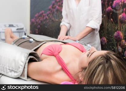 Woman doing cosmetic procedures in spa clinic