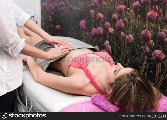 Woman doing cosmetic procedures in spa clinic