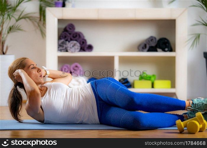 Woman Doing Crunches Indoors.