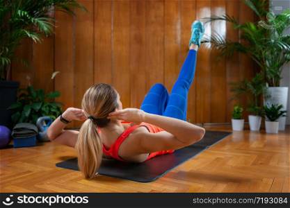 Woman doing Crunches on High-intensity interval training at home