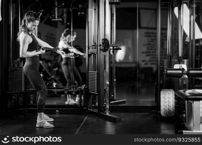 Woman Doing Exercise on a Machine in a Gym