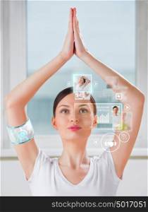 Woman doing exercise wearing smart wearable device with futuristic interface