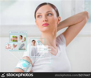 Woman doing exercise wearing smart wearable device with futuristic interface
