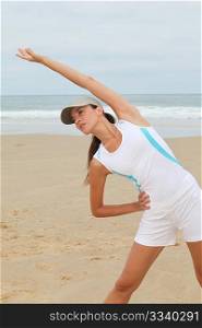 Woman doing exercises on the beach