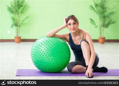 Woman doing exercises with swiss ball