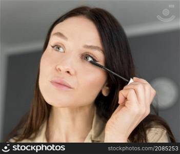 woman doing eyeliner