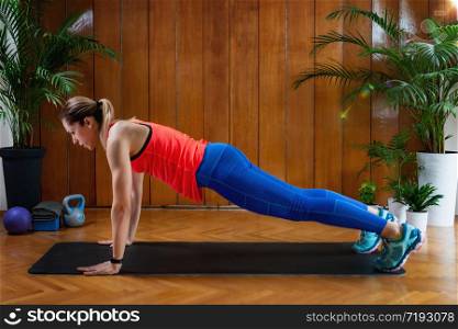 Woman doing High-intensity interval training at home. Woman Doing High Plank Exercise