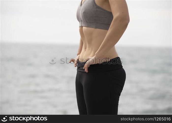 woman doing hypopressive exercise in the sea