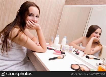 Woman doing make-up at home preparing for party