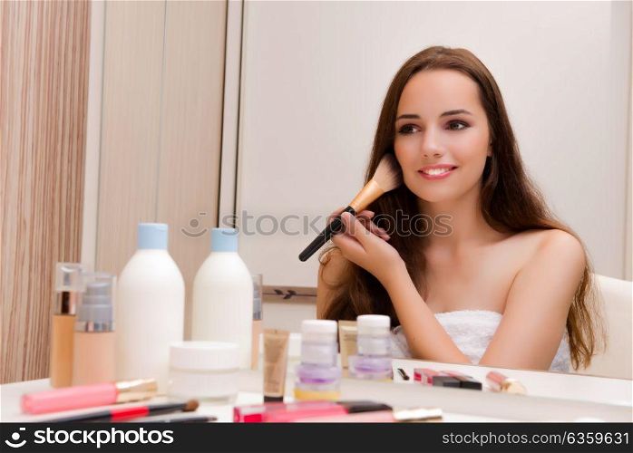Woman doing make-up at home preparing for party